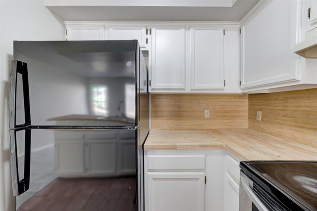201 Kathleen Dr, Midwest City, OK 73110 - kitchen with freestanding refrigerator, white cabinets, backsplash, dark wood-type flooring, and wood counters