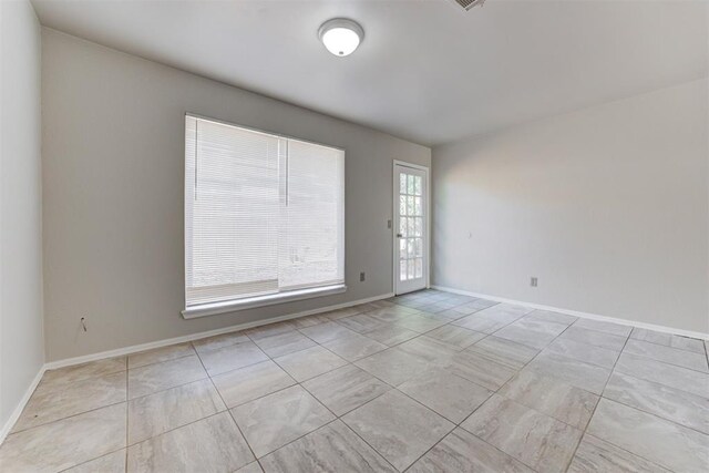 201 Kathleen Dr, Midwest City, OK 73110 - spare room with tile patterned floors and baseboards