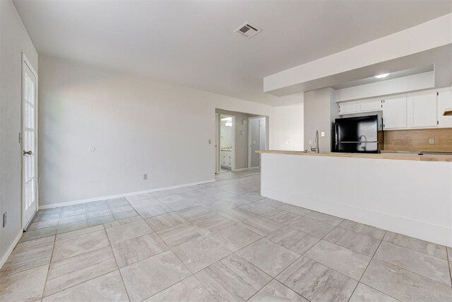 201 Kathleen Dr, Midwest City, OK 73110 - unfurnished living room with a sink and baseboards