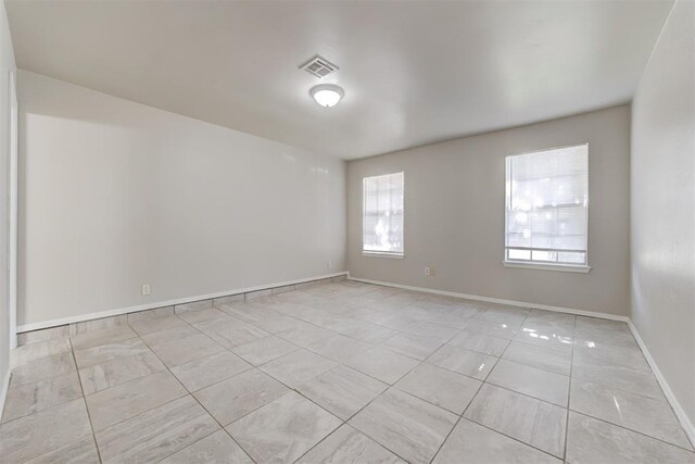 201 Kathleen Dr, Midwest City, OK 73110 - unfurnished room with light tile patterned floors and baseboards