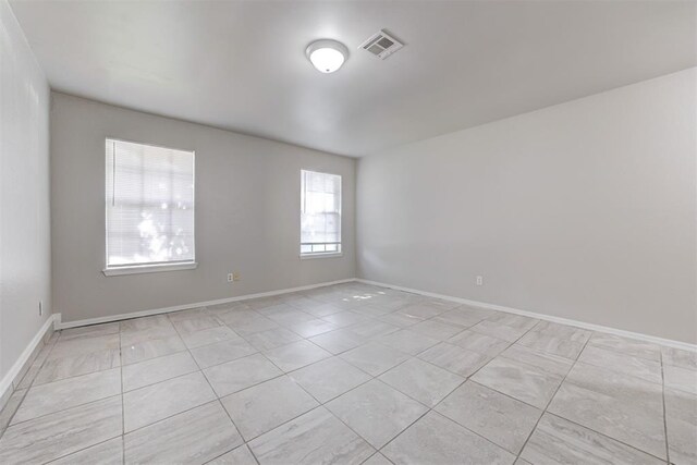 201 Kathleen Dr, Midwest City, OK 73110 - empty room featuring light tile patterned floors and baseboards