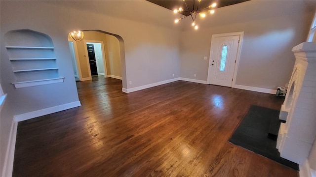 929 NE 21st St, Oklahoma City, OK 73105 - foyer entrance with a chandelier, dark wood-style floors, and arched walkways