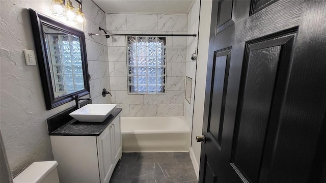 929 NE 21st St, Oklahoma City, OK 73105 - full bath with vanity, toilet, plenty of natural light, a textured wall, and shower / bathtub combination