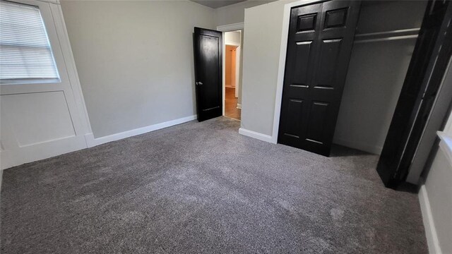 929 NE 21st St, Oklahoma City, OK 73105 - unfurnished bedroom with carpet flooring, a closet, and baseboards