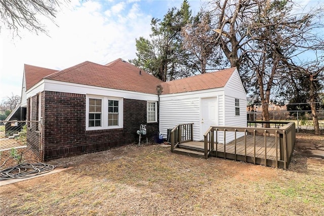 929 NE 21st St, Oklahoma City, OK 73105 - back of property featuring a deck and brick siding