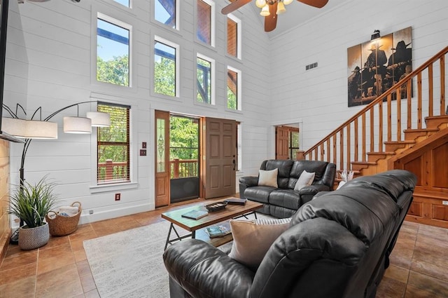 83 Bobber Rd, Broken Bow, OK 74728 - living room featuring a high ceiling, healthy amount of natural light, a ceiling fan, and stairs