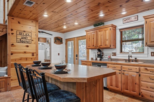 83 Bobber Rd, Broken Bow, OK 74728 - kitchen featuring recessed lighting, a sink, dishwasher, a breakfast bar area, and light tile patterned floors