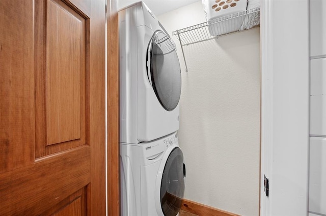 83 Bobber Rd, Broken Bow, OK 74728 - laundry area featuring stacked washer / dryer and baseboards