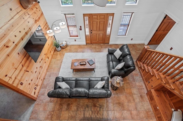 83 Bobber Rd, Broken Bow, OK 74728 - tiled living room with wooden walls and baseboards