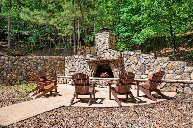 83 Bobber Rd, Broken Bow, OK 74728 - view of patio / terrace with an outdoor stone fireplace