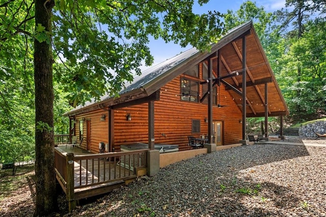 83 Bobber Rd, Broken Bow, OK 74728 - view of side of home with faux log siding, a wooden deck, metal roof, and a patio area