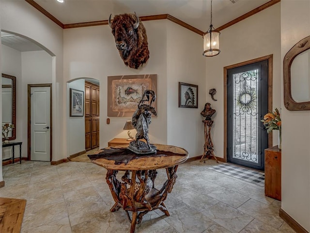 3122 Thornbrooke Blvd, Edmond, OK 73013 - entryway featuring arched walkways, baseboards, ornamental molding, and a towering ceiling