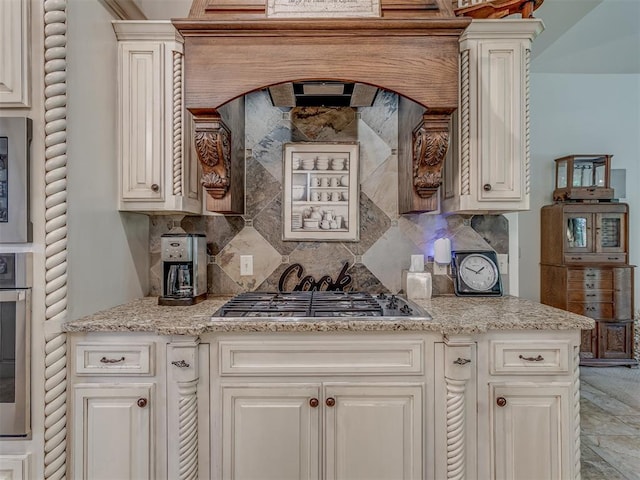 3122 Thornbrooke Blvd, Edmond, OK 73013 - kitchen with stainless steel appliances, decorative backsplash, light stone counters, and white cabinetry