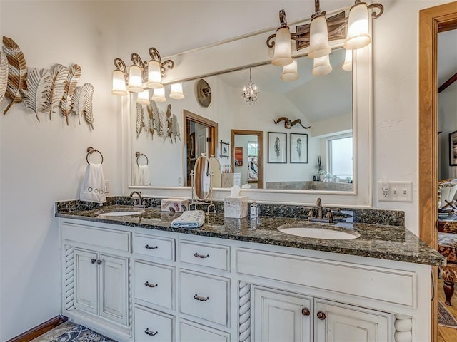 3122 Thornbrooke Blvd, Edmond, OK 73013 - full bathroom featuring double vanity, lofted ceiling, and a chandelier
