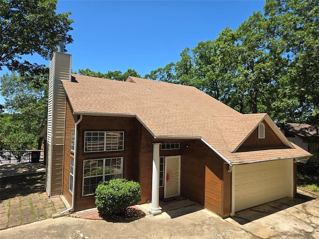 110534 S 4183rd Rd, Checotah, OK 74426 - view of front of home featuring a shingled roof and a chimney