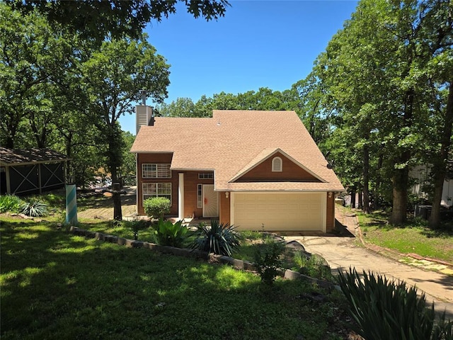110534 S 4183rd Rd, Checotah, OK 74426 - view of front of home featuring a chimney, an attached garage, driveway, a front lawn, and a shingled roof