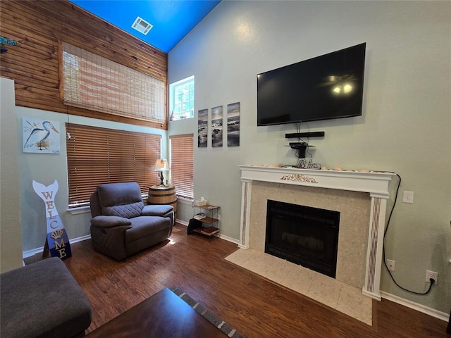 110534 S 4183rd Rd, Checotah, OK 74426 - living area featuring a fireplace with flush hearth, wood finished floors, baseboards, and high vaulted ceiling