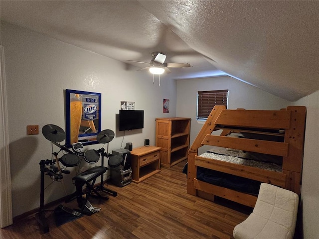 110534 S 4183rd Rd, Checotah, OK 74426 - bedroom featuring vaulted ceiling, wood finished floors, a textured ceiling, and a ceiling fan
