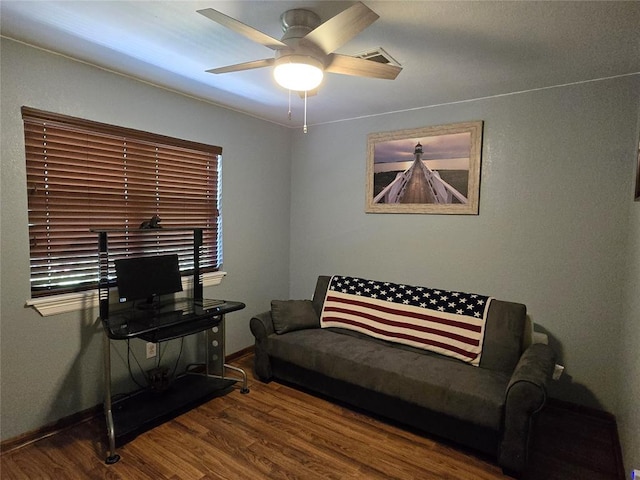 110534 S 4183rd Rd, Checotah, OK 74426 - living room featuring wood finished floors, a ceiling fan, and baseboards