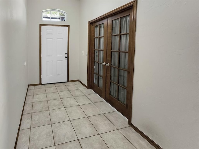 3105 SW 104th Ter, Oklahoma City, OK 73159 - foyer entrance with french doors, light tile patterned floors, and baseboards