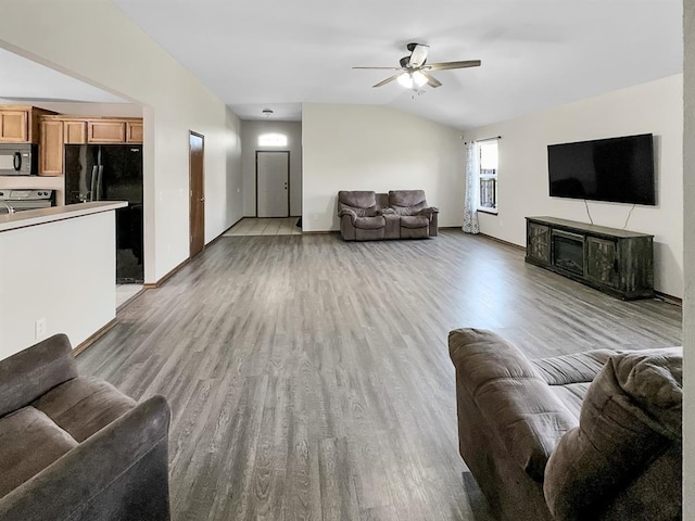 3105 SW 104th Ter, Oklahoma City, OK 73159 - living area with vaulted ceiling, light wood-style floors, ceiling fan, baseboards, and a fireplace