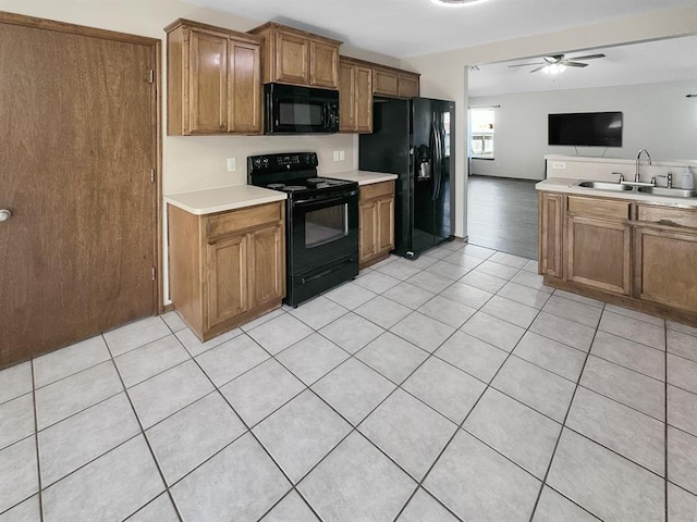 3105 SW 104th Ter, Oklahoma City, OK 73159 - kitchen featuring black appliances, a sink, a ceiling fan, open floor plan, and light countertops
