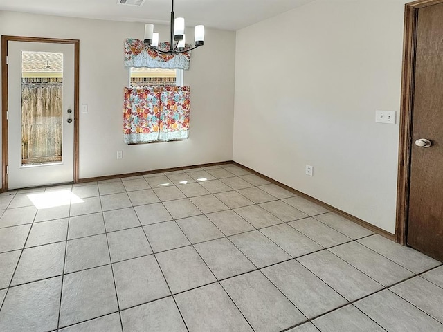 3105 SW 104th Ter, Oklahoma City, OK 73159 - spare room featuring a chandelier, light tile patterned flooring, and baseboards