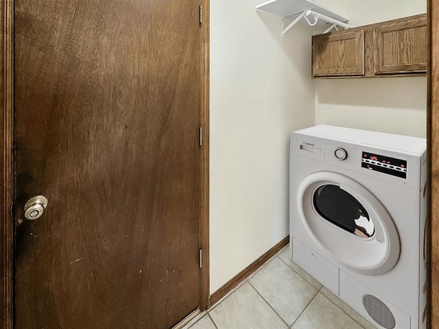 3105 SW 104th Ter, Oklahoma City, OK 73159 - laundry area with washer / dryer, light tile patterned floors, cabinet space, and baseboards