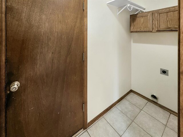 3105 SW 104th Ter, Oklahoma City, OK 73159 - washroom featuring electric dryer hookup, light tile patterned floors, and baseboards