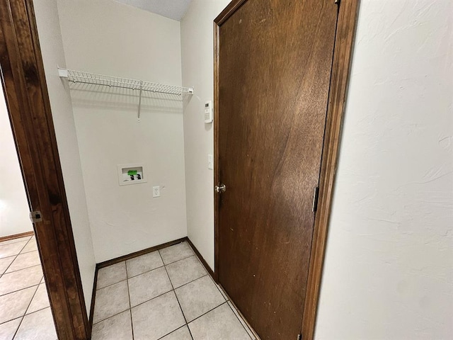 3105 SW 104th Ter, Oklahoma City, OK 73159 - laundry area with washer hookup, light tile patterned flooring, and baseboards