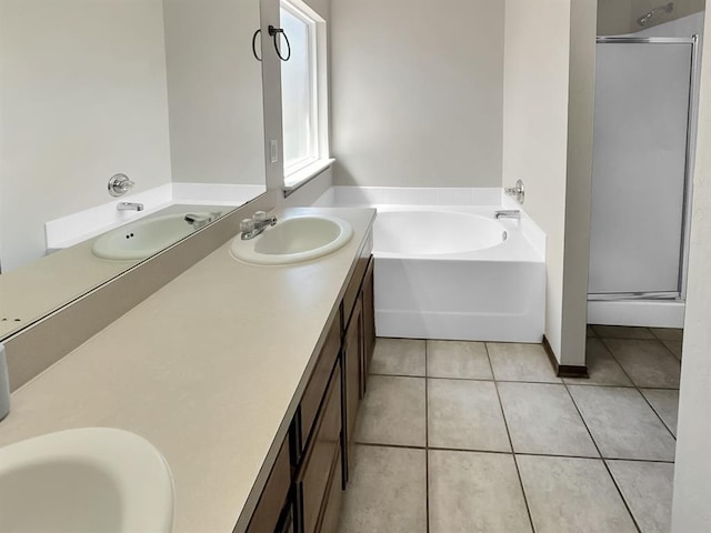 3105 SW 104th Ter, Oklahoma City, OK 73159 - full bathroom featuring double vanity, a bath, tile patterned floors, and a stall shower