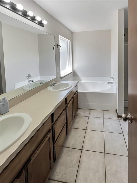 3105 SW 104th Ter, Oklahoma City, OK 73159 - full bathroom featuring double vanity, a garden tub, and tile patterned floors