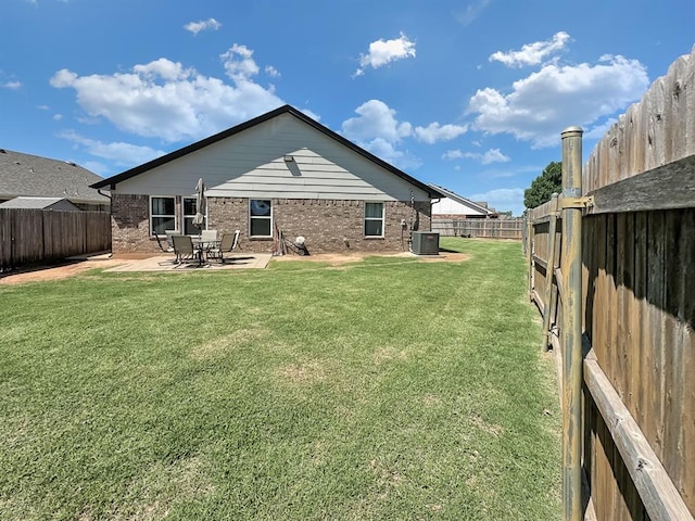 3105 SW 104th Ter, Oklahoma City, OK 73159 - back of property with cooling unit, brick siding, and a patio