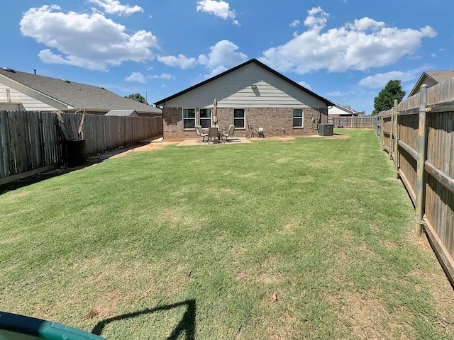 3105 SW 104th Ter, Oklahoma City, OK 73159 - back of house featuring central air condition unit, brick siding, and a patio area