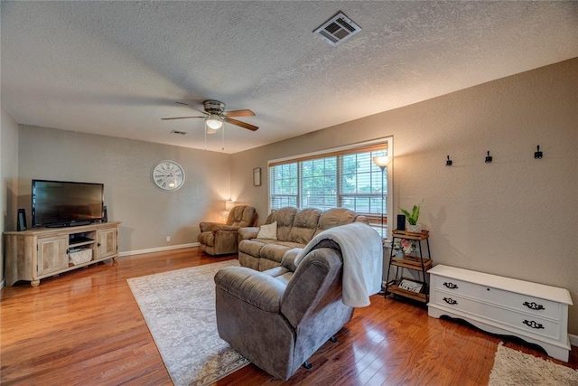 408 S 6th St, Davis, OK 73030 - living area featuring ceiling fan, a textured ceiling, wood finished floors, baseboards, and a textured wall