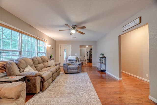 408 S 6th St, Davis, OK 73030 - living area featuring a ceiling fan, light wood-style floors, and baseboards