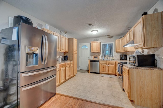 408 S 6th St, Davis, OK 73030 - kitchen featuring stainless steel appliances, under cabinet range hood, tasteful backsplash, light brown cabinetry, and light countertops