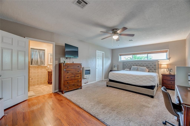 408 S 6th St, Davis, OK 73030 - bedroom with heating unit, a textured ceiling, wood finished floors, an office area, and a ceiling fan