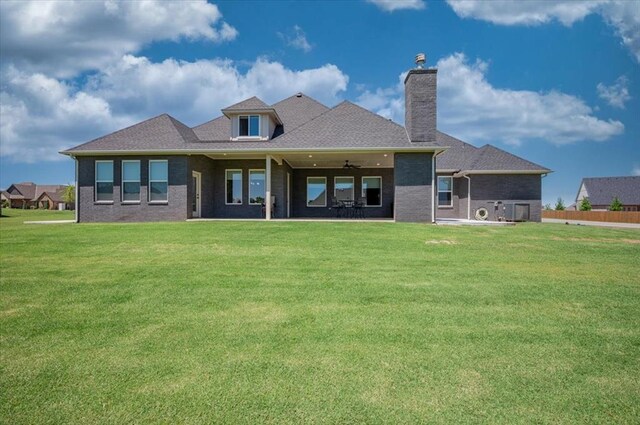 1008 Collis Way, Newcastle, OK 73065 - back of house featuring a chimney, ceiling fan, a yard, brick siding, and a patio