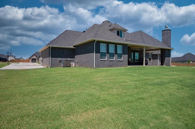 1008 Collis Way, Newcastle, OK 73065 - back of property featuring a patio, a yard, brick siding, and cooling unit