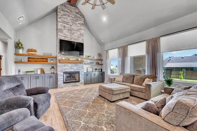 1008 Collis Way, Newcastle, OK 73065 - living room with high vaulted ceiling, light wood finished floors, ceiling fan, a fireplace, and beamed ceiling