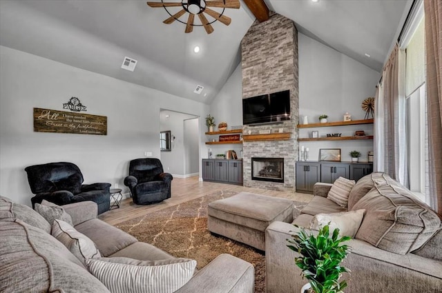 1008 Collis Way, Newcastle, OK 73065 - living room with a ceiling fan, high vaulted ceiling, beam ceiling, light wood-style flooring, and a fireplace