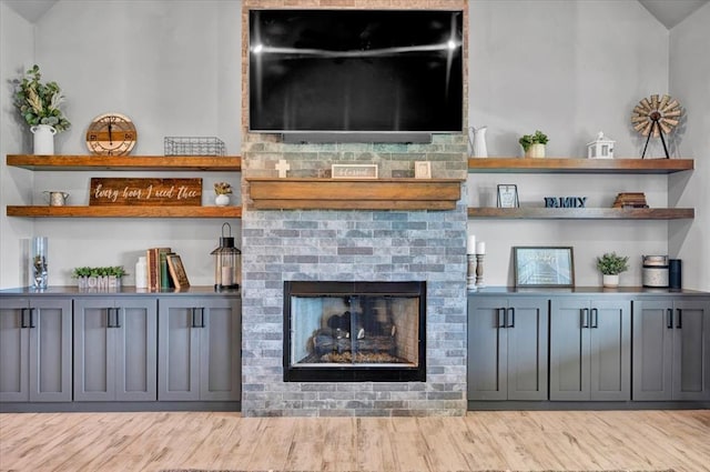 1008 Collis Way, Newcastle, OK 73065 - living room featuring a brick fireplace and wood finished floors