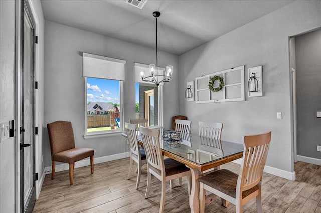 1008 Collis Way, Newcastle, OK 73065 - dining area featuring light wood-style flooring, a chandelier, and baseboards