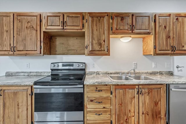 2273 County Road 1240, Blanchard, OK 73010 - kitchen with appliances with stainless steel finishes, a sink, light countertops, and brown cabinetry