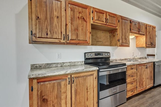2273 County Road 1240, Blanchard, OK 73010 - kitchen with stainless steel appliances, a sink, light countertops, dark wood-style flooring, and brown cabinets