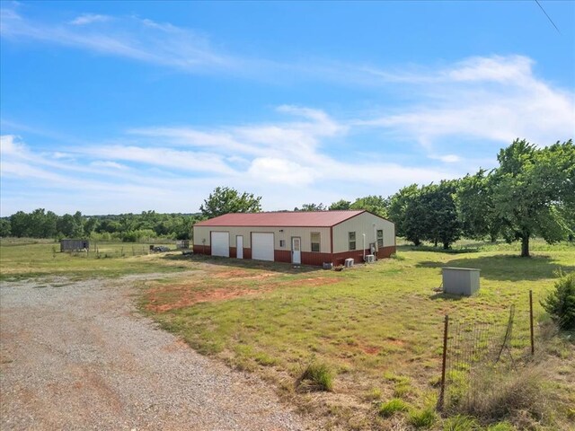 2273 County Road 1240, Blanchard, OK 73010 - view of front of property featuring an outdoor structure, a detached garage, driveway, and a rural view