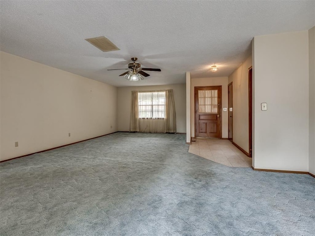 4004 N Shannon Ave, Bethany, OK 73008 - spare room with light colored carpet, ceiling fan, baseboards, and a textured ceiling