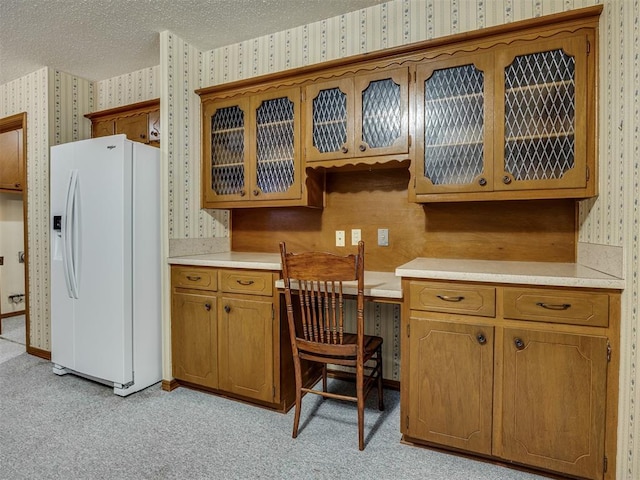 4004 N Shannon Ave, Bethany, OK 73008 - kitchen featuring wallpapered walls, white fridge with ice dispenser, light countertops, light carpet, and brown cabinets