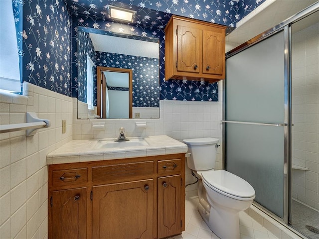 4004 N Shannon Ave, Bethany, OK 73008 - full bath featuring wallpapered walls, vanity, tile walls, toilet, and wainscoting